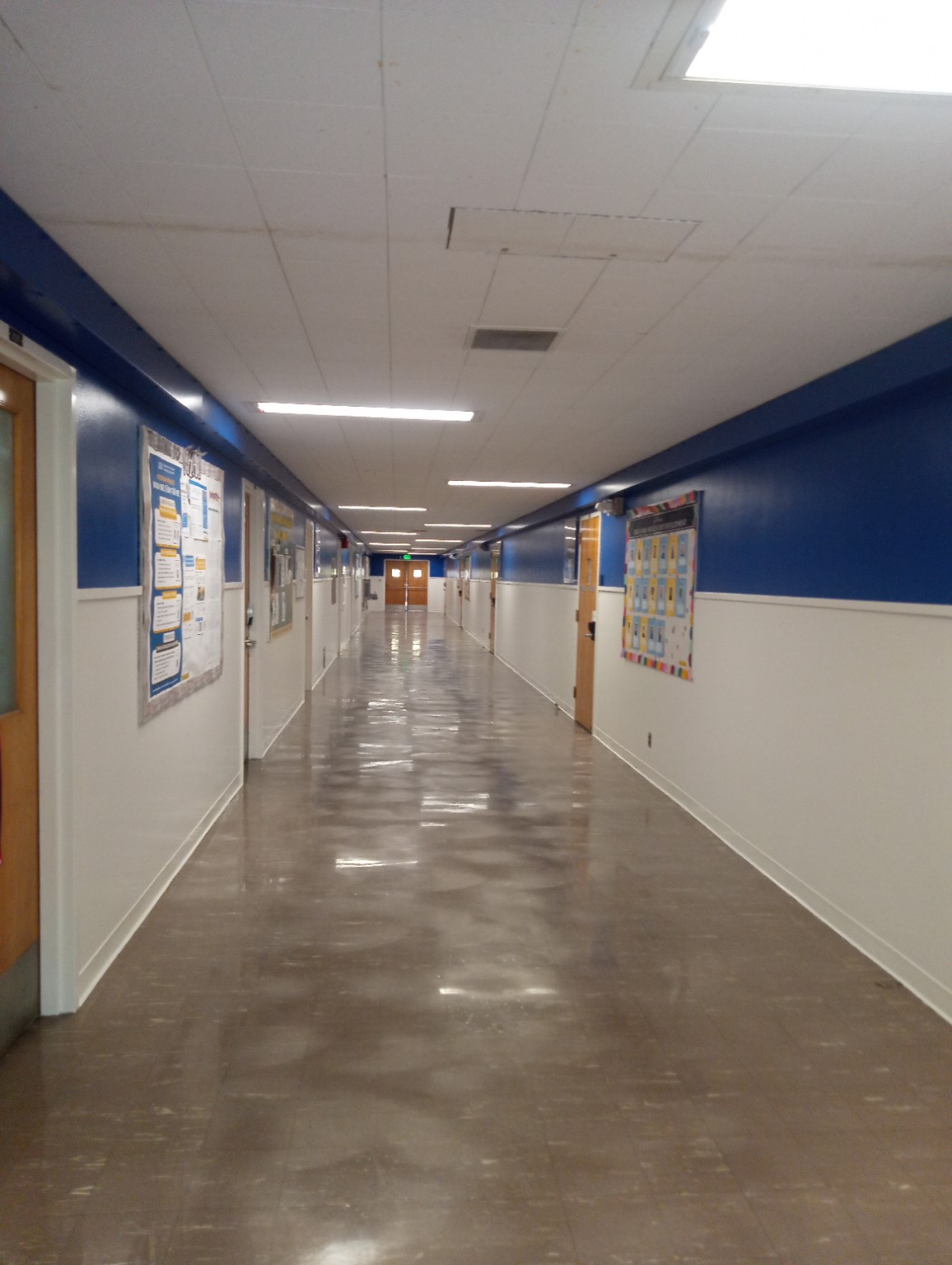 Finished blue and white institutional hallway